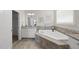 Bathroom showcases a large soaking tub with granite counters and tile surround, offering a serene retreat at 1212 Stonemill Falls Dr, Wake Forest, NC 27587