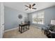 Cozy bedroom features soft blue walls, a plush carpet, and natural light, creating a comfortable space at 1212 Stonemill Falls Dr, Wake Forest, NC 27587