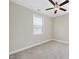 Simple, carpeted bedroom with a ceiling fan and a window, offering a clean and functional space at 1212 Stonemill Falls Dr, Wake Forest, NC 27587