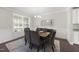 Inviting dining room with natural light streaming through the windows, creating a warm and inviting space for meals at 1212 Stonemill Falls Dr, Wake Forest, NC 27587