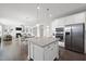 Open kitchen with granite island, stainless steel appliances, and view into the living room at 1212 Stonemill Falls Dr, Wake Forest, NC 27587