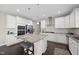 Modern kitchen featuring white cabinetry, granite countertops, and stainless steel appliances at 1212 Stonemill Falls Dr, Wake Forest, NC 27587