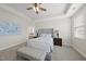 Bright main bedroom boasts a decorative ceiling fan, soft carpet, and upholstered bed frame with a bench at 1212 Stonemill Falls Dr, Wake Forest, NC 27587