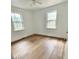 Cozy bedroom featuring hardwood floors, neutral paint, and ample natural light at 123 Barclay Rd, Chapel Hill, NC 27516