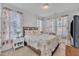 Cozy bedroom features a floral comforter, neutral carpet, and natural light coming through the windows at 123 Carbone Ln, Clayton, NC 27527
