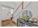 Welcoming foyer featuring hardwood floors, a stylish console table, and staircase leading to the upper level at 123 Carbone Ln, Clayton, NC 27527
