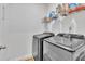 Functional laundry room with modern washer and dryer, and overhead shelving at 123 Carbone Ln, Clayton, NC 27527