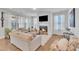 Cozy living room featuring a fireplace, plush seating, large windows, and hardwood floors creating a relaxing atmosphere at 123 Carbone Ln, Clayton, NC 27527