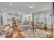 Open-concept living room connected to a modern kitchen, featuring hardwood floors, comfortable seating, and ample natural light at 123 Carbone Ln, Clayton, NC 27527