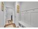 Convenient mud room with built-in bench, coat hooks, and adjacent laundry room at 123 Carbone Ln, Clayton, NC 27527