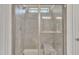 Glass enclosed shower featuring tile surround, built-in bench, and a frosted window for natural light at 123 Carbone Ln, Clayton, NC 27527