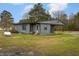 Back of the home showcasing the home's exterior, yard and an attached porch at 1239 Brogden Rd, Smithfield, NC 27577