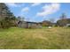 Exterior view of the home featuring a spacious yard and mature trees at 1239 Brogden Rd, Smithfield, NC 27577
