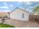 Back of house features gray siding, a wood fence, an outdoor grill, and concrete area at 1304 Drew St, Durham, NC 27701