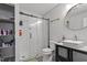 Modern bathroom with a glass-enclosed shower, stylish vanity, and decorative black and white patterned flooring at 1304 Drew St, Durham, NC 27701