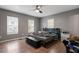 This bedroom features wood-look floors, three windows, and gray colored walls at 1304 Drew St, Durham, NC 27701