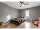 Bright bedroom with wood-look flooring, ceiling fan, and a window providing natural light at 1304 Drew St, Durham, NC 27701