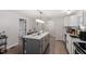 Bright kitchen features an island with marble countertop, gray cabinets, and stainless steel appliances at 1304 Drew St, Durham, NC 27701
