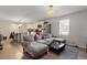 Living room showcases a plush gray sofa, a dark coffee table, and open access to a kitchen area at 1304 Drew St, Durham, NC 27701