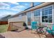 Backyard deck area with a table and two chairs, with gray siding and a blue sky above at 131 Woodglen Dr, Clayton, NC 27527