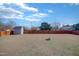 A spacious backyard featuring a shed, a wooden fence, and a fire pit at 131 Woodglen Dr, Clayton, NC 27527