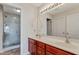 Modern bathroom features a double vanity, large mirror, and a glass shower at 131 Woodglen Dr, Clayton, NC 27527