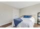 Bright bedroom with a light wood bedframe, two blue pillows, a blue blanket, and wood floors at 131 Woodglen Dr, Clayton, NC 27527