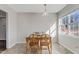 Bright dining room featuring a window and a wooden table with four chairs, illuminated by a pendant light fixture at 131 Woodglen Dr, Clayton, NC 27527