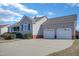 Side view of a charming single-story house with an attached two-car garage and large concrete driveway at 131 Woodglen Dr, Clayton, NC 27527