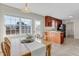 Eat-in kitchen features wood table near window, plus dark cabinets and stainless appliances at 131 Woodglen Dr, Clayton, NC 27527