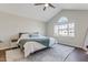 Spacious main bedroom boasts vaulted ceiling, ceiling fan, and large arched window at 131 Woodglen Dr, Clayton, NC 27527