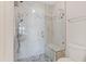 This bathroom features a walk-in glass shower with marble-look tiles and bench seating at 131 Woodglen Dr, Clayton, NC 27527