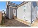 The backyard shows the side of the house with wood-planked exterior and a door for entry at 1312 Big Falls Dr, Wendell, NC 27591