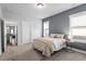 Comfortable bedroom featuring carpet, a decorative accent wall, and two windows for natural light at 1312 Big Falls Dr, Wendell, NC 27591