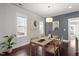 Bright dining room with a stylish table, hardwood floors, and modern decor at 1312 Big Falls Dr, Wendell, NC 27591