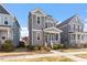 Charming two-story home with a cozy front porch, neutral siding, and professionally landscaped yard at 1312 Big Falls Dr, Wendell, NC 27591