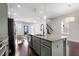 Open-concept kitchen with a central island, granite countertop, stainless appliances, and hardwood floors at 1312 Big Falls Dr, Wendell, NC 27591