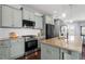 Modern kitchen featuring stainless steel appliances, granite countertops, and stylish cabinetry at 1312 Big Falls Dr, Wendell, NC 27591