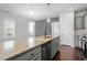 Large kitchen island featuring stainless steel appliances, sink, and elegant counter space at 1312 Big Falls Dr, Wendell, NC 27591