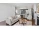 Open-concept living room with a comfortable sofa, fireplace, and a view of the kitchen at 1312 Big Falls Dr, Wendell, NC 27591