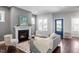 Comfortable living area with fireplace, gray walls, natural light, and hardwood flooring at 1312 Big Falls Dr, Wendell, NC 27591