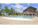 Community pool featuring a slide, splash features, lounge chairs, and nearby clubhouse at 1312 Big Falls Dr, Wendell, NC 27591
