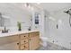 Bathroom featuring double sinks, unique tile flooring, and glass shower at 163 Periwinkle Pl, Clayton, NC 27527