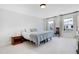 Bright bedroom with two windows and soft neutral carpet flooring at 163 Periwinkle Pl, Clayton, NC 27527