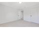 Empty bedroom with a door to a closet and a door to the hallway at 163 Periwinkle Pl, Clayton, NC 27527
