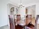 Formal dining room features a wood table with seating for four and a built-in cabinet at 163 Periwinkle Pl, Clayton, NC 27527