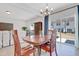 The dining area includes a glass door with backyard views and a modern chandelier above the table at 163 Periwinkle Pl, Clayton, NC 27527