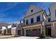 Lovely townhome with a brick and siding facade, two-car garage, and attractive landscaping at 163 Periwinkle Pl, Clayton, NC 27527