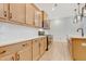 A bright kitchen with stainless steel appliances, white countertops and modern light fixtures at 163 Periwinkle Pl, Clayton, NC 27527