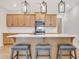 Well-equipped kitchen featuring a large island with seating and stainless steel appliances at 163 Periwinkle Pl, Clayton, NC 27527